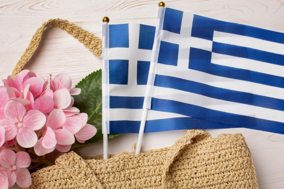 An image of two Greece flags coming out from a female bag