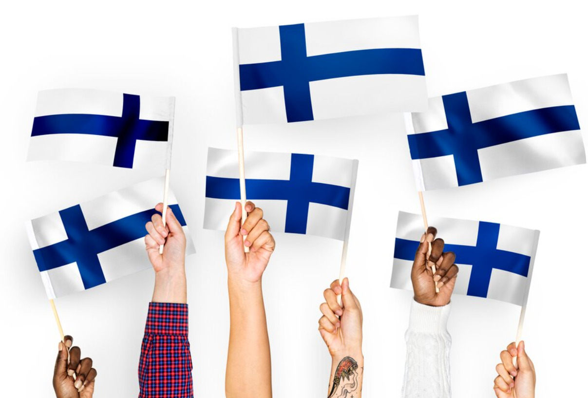 And image of six different hands holding Finland flag