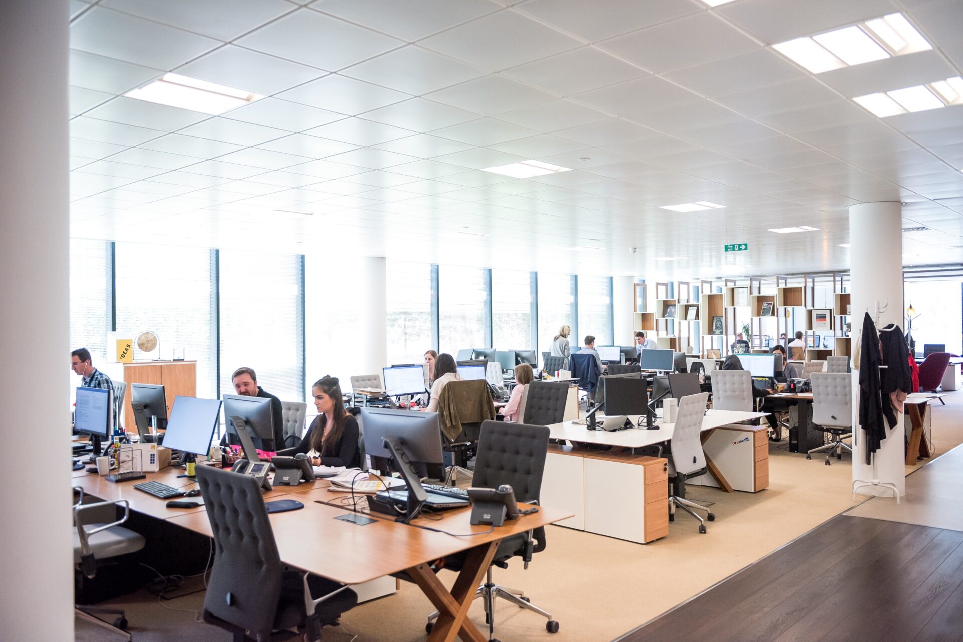 An image of a huge modern office filled with numbers of discs and workers