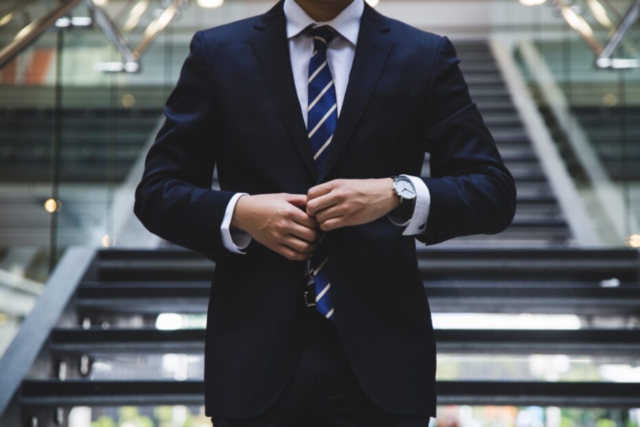 An image of a businessman wearing a blue suit without showing his face