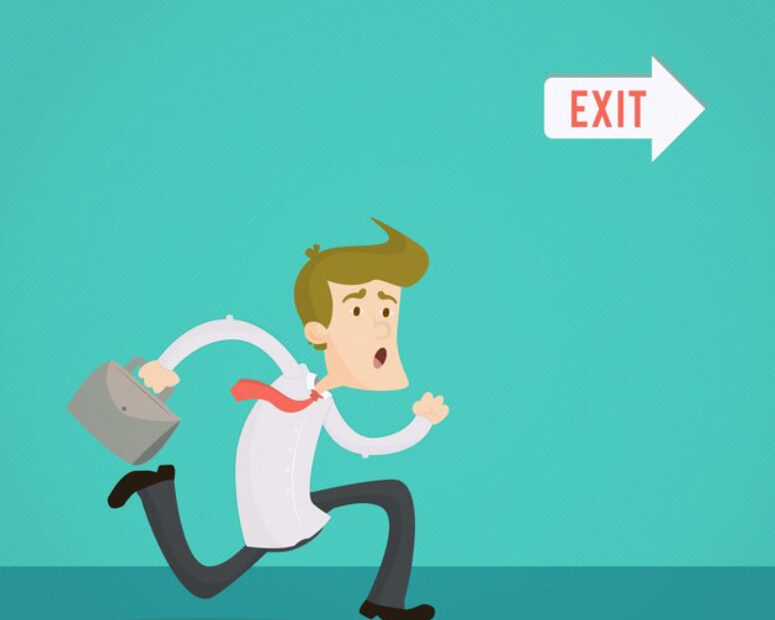 A picture of an employee running towards an exit sign, capturing a sense of urgency or the end of a workday.