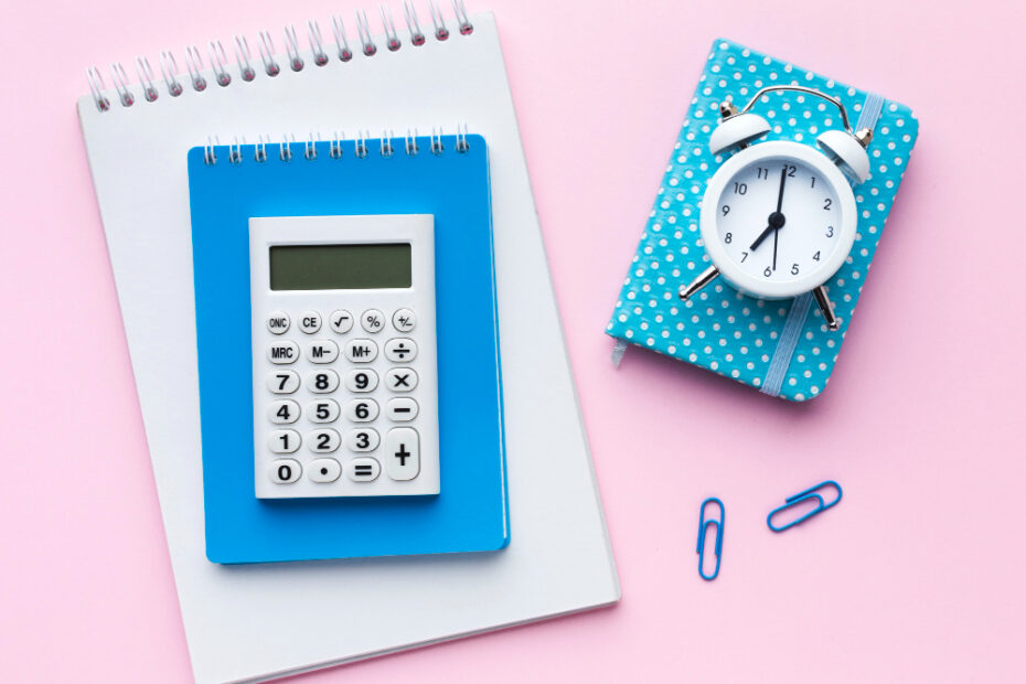 An image with a pink background, calculator, and a small clock.