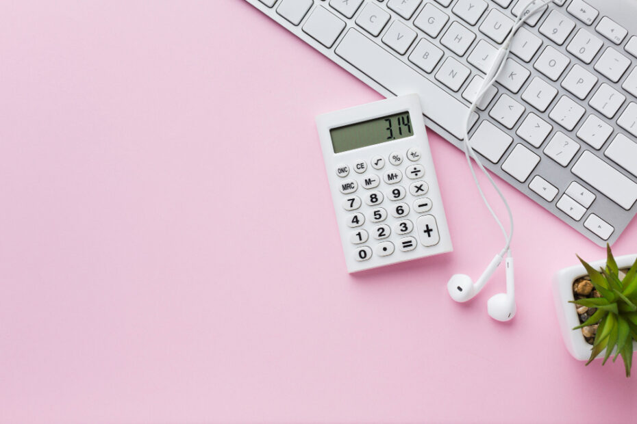 A white calculator displaying the number 3.14 next to white earphones and a keyboard on a pink background.