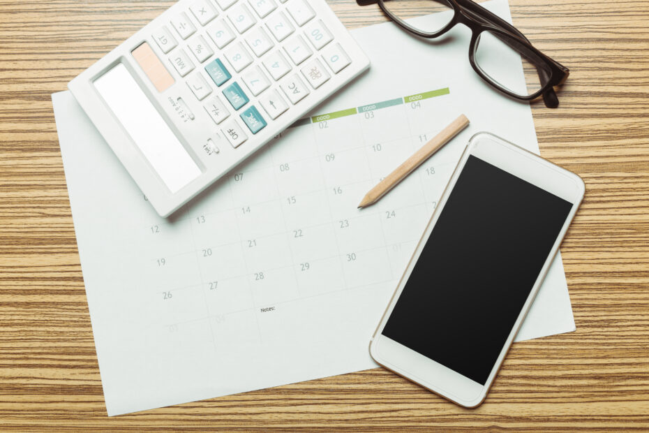 Office table with smartphone on it. View from above