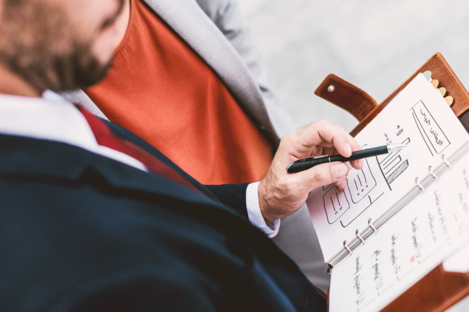 an employee holding a ben to mark some thing in his individual development plan.